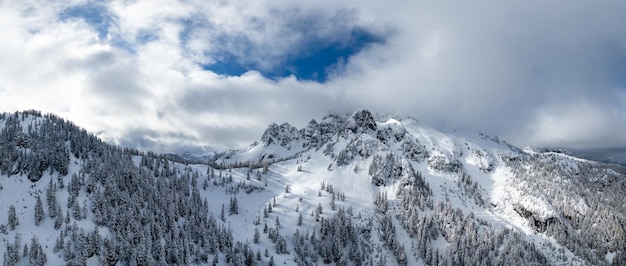 Aerial canadian mountain landscape covered in snow and clouds