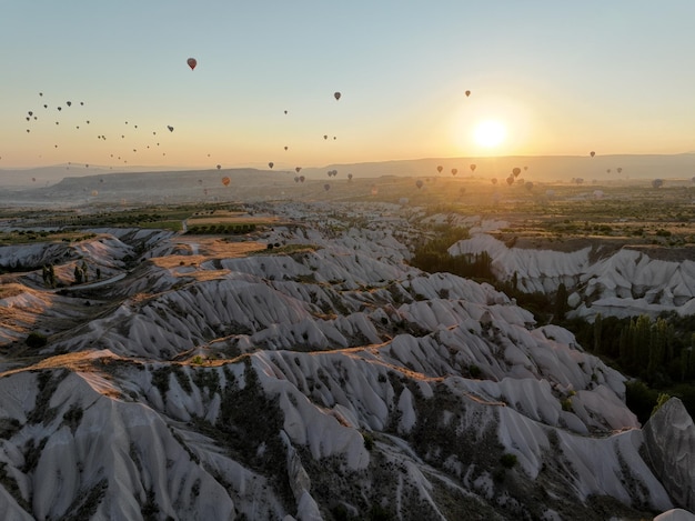 Aerial cinematic drone view of colorful hot air balloon flying over Cappadocia