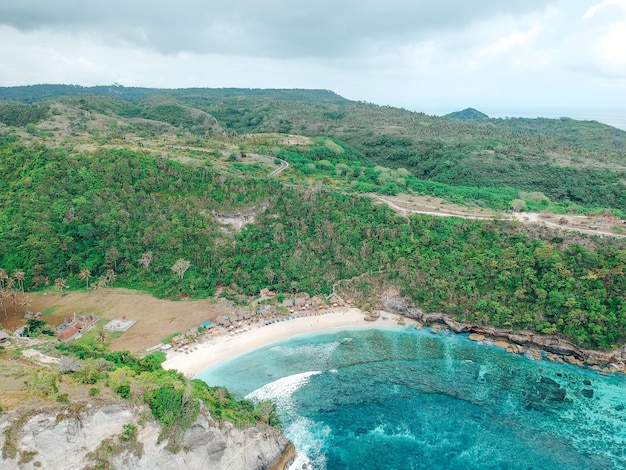 Aerial drone top view of coral beach and blue ocean waves In Nusa Penida Bali Indonesia Overhead View Of Rocky Coast And Coves