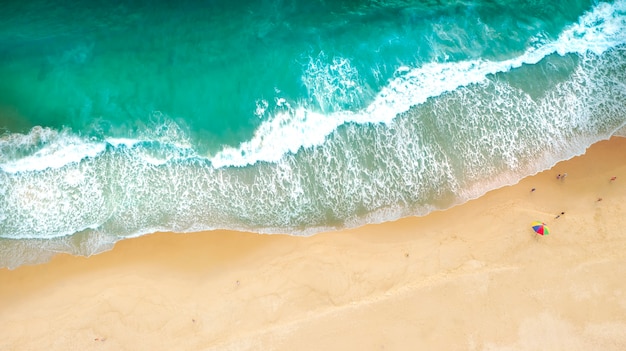 aerial drone top view crowd of happy people relax at tropical beach with sunset in phuket, thailand,