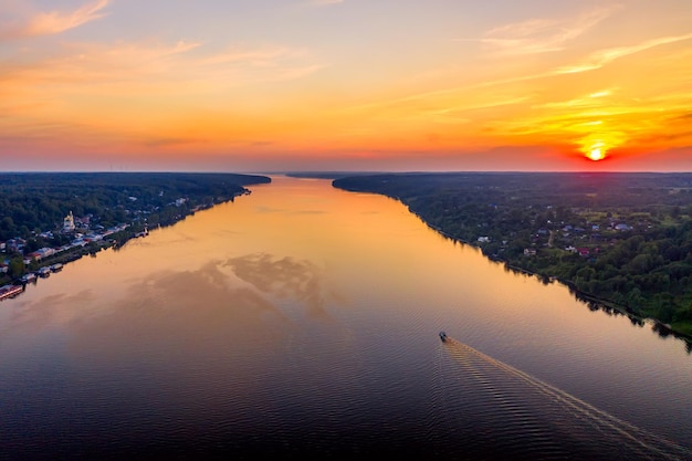 Aerial drone view of ancient russian town Ples on the Volga river with colorful sunset.