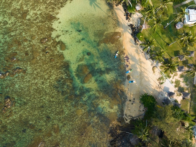 Aerial drone view of beautiful beach with turquoise sea water and palm trees of Gulf of Thailand Kood island Thailand