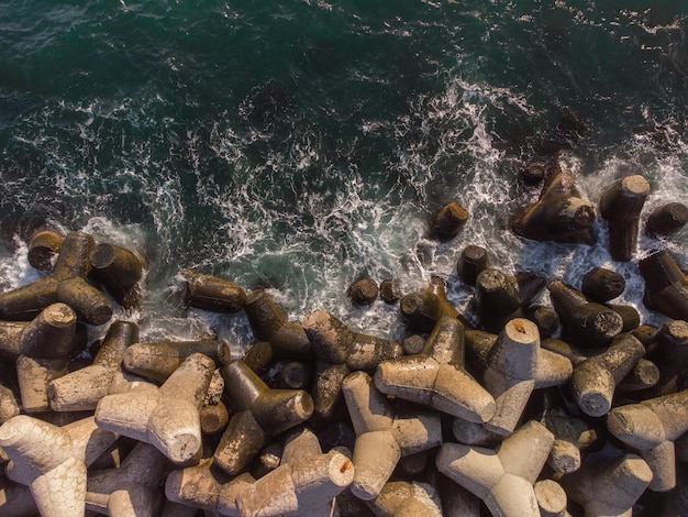 Aerial drone view of a breakwater breakwater in the sea a collection of concrete breakers