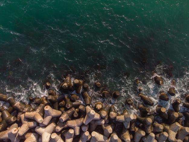 Aerial drone view of a breakwater breakwater in the sea a collection of concrete breakers