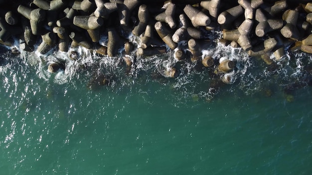 Aerial drone view of a breakwater breakwater in the sea a collection of concrete breakers