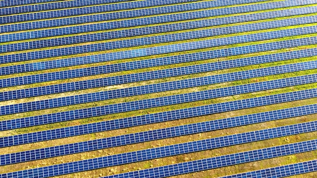 Aerial drone view flight over solar power station panels