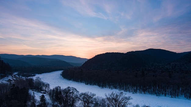 Aerial drone view in mountain forest winter landscape snowy fir and pine trees snowy tree branch in