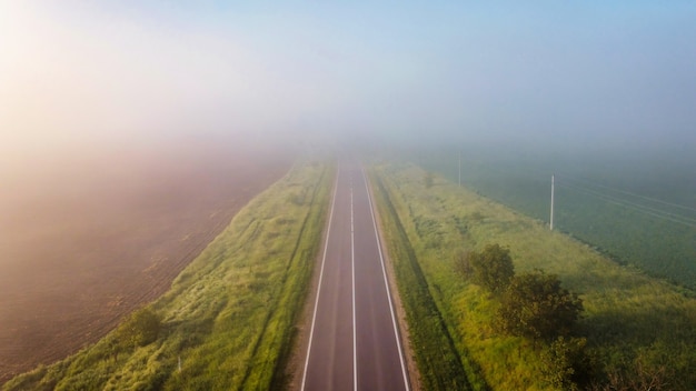 Aerial drone view of nature in Moldova at morning Fields on both sides of the road with fog