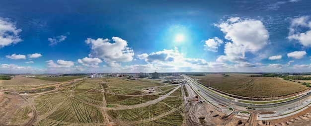 Aerial drone view of new road development and residential construction site Panorama of the construction of a new road Shooting from a drone Construction site from above