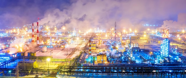 Aerial drone view of petrol industrial zone or oil refinery in Yaroslavl Russia during winter at night Banner wide format