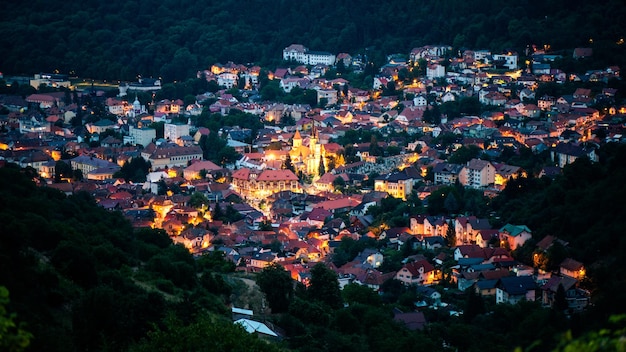 Aerial drone view of the Saint Nicholas Church in Brasov at night Romania