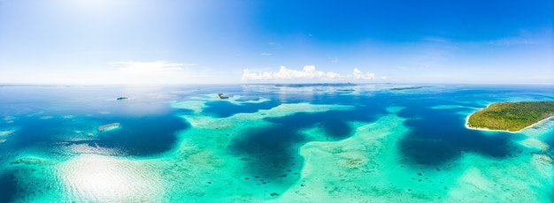 Aerial: exotic tropical island white sand beach away from it all, coral reef caribbean sea turquoise water