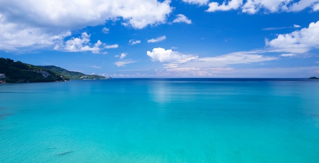 Aerial flying drone view Waves water surface texture on sunny tropical ocean in Phuket island