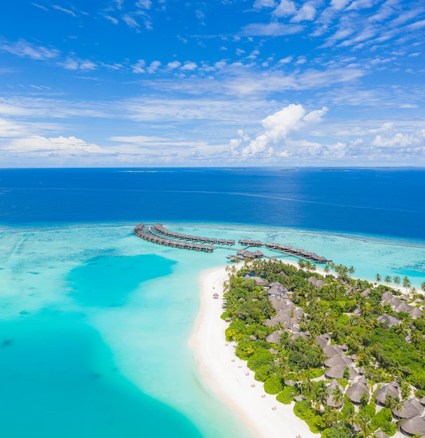 Aerial island shore, tropical coast of Maldives islands. Pristine beach, lagoon seascape, sand palms