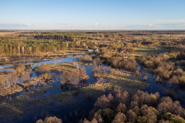 Aerial landscape of valley of small river flooded in Spring