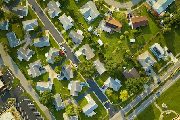 Aerial landscape view of suburban private houses between green palm trees in Florida quiet rural area