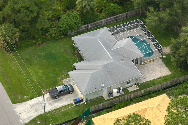 Aerial landscape view of suburban private houses between green palm trees in Florida quiet rural area