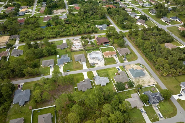 Aerial landscape view of suburban private houses between green palm trees in Florida quiet rural area