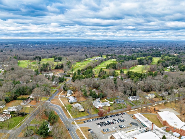 Aerial of Longmeadow country club in late fall deciduous trees green grass buildings