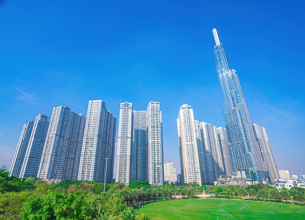 Aerial morning view with sunny and green trees at Landmark 81 it is a super tall skyscraper with development buildings along Saigon river in Ho Chi Minh city Vietnam Business travel concept