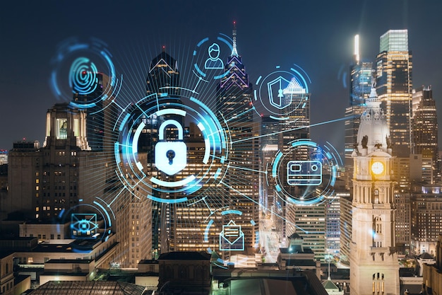 Aerial panoramic cityscape of Philadelphia financial downtown at night time Pennsylvania USA Glowing Padlock hologram The concept of cyber security to protect companies confidential information