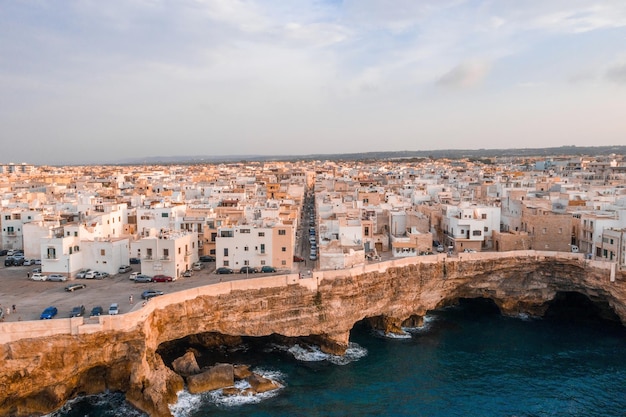 Aerial panoramic cityscape of Polignano a Mare town, Puglia region, Italy near Bari city, Europe. Superb scenic view of Adriatic sea. Traveling concept background.