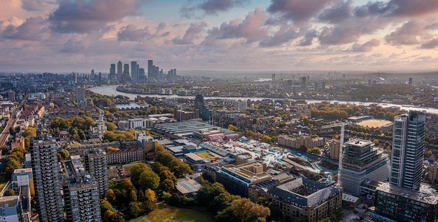 Aerial panoramic scene of the London city financial district with many iconic skyscrapers near river Thames.