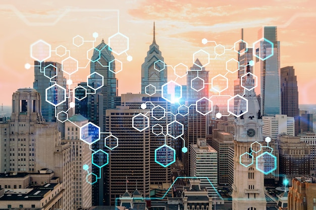 Aerial panoramic skyline of Philadelphia financial downtown Pennsylvania USA City Hall Clock Tower at sunset Decentralized economy Blockchain cryptocurrency and cryptography concept hologram