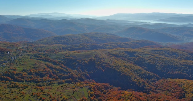 Aerial panoramic top view on beautiful in autumn forest landscape the mountains at view of hills cov