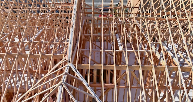 Aerial panoramic top view on wooden roof beams trusses system framed construction in new home