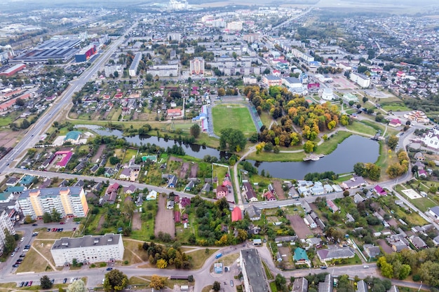 Aerial panoramic view from great height of provincial town with a private sector and highrise urban apartment buildings