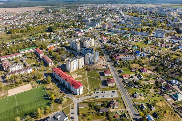 Aerial panoramic view from great height of provincial town with a private sector and highrise urban apartment buildings