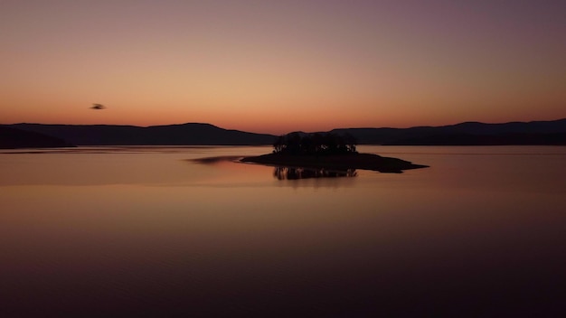 Aerial panoramic view of Island on a Batak Reservoir in sunrise Rhodopa Mountains Bulgaria