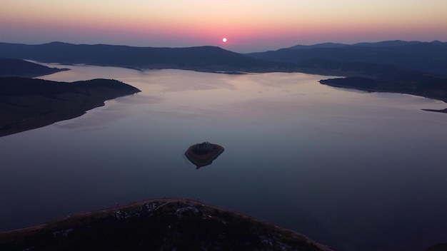 Aerial panoramic view of Island on a Batak Reservoir in sunrise Rhodopa Mountains Bulgaria