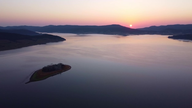 Aerial panoramic view of Island on a Batak Reservoir in sunrise Rhodopa Mountains Bulgaria