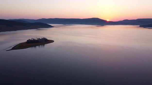 Aerial panoramic view of Island on a Batak Reservoir in sunrise Rhodopa Mountains Bulgaria