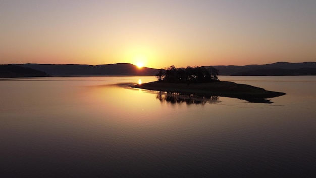 Aerial panoramic view of Island on a Batak Reservoir in sunrise Rhodopa Mountains Bulgaria