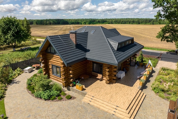 Aerial panoramic view on wooden eco house or homestead in green village