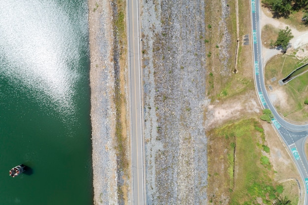 Aerial photo from flying drone of asphalt road and bicycle lane around the dam