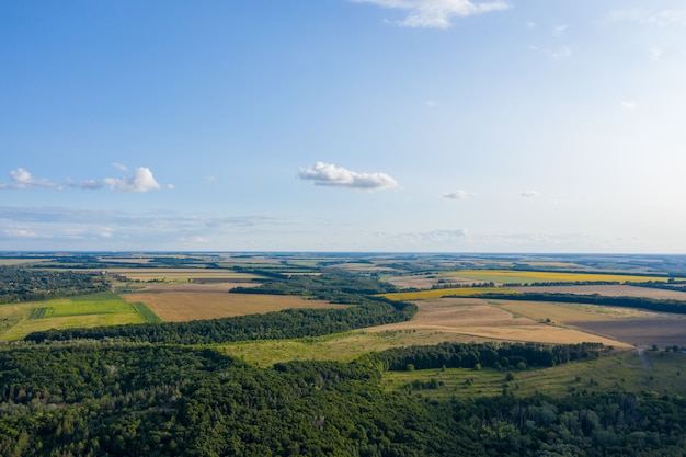 Aerial photo from a plane, top view, field roads and city