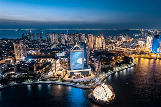 Aerial photography night view of modern city buildings in Qingdao China