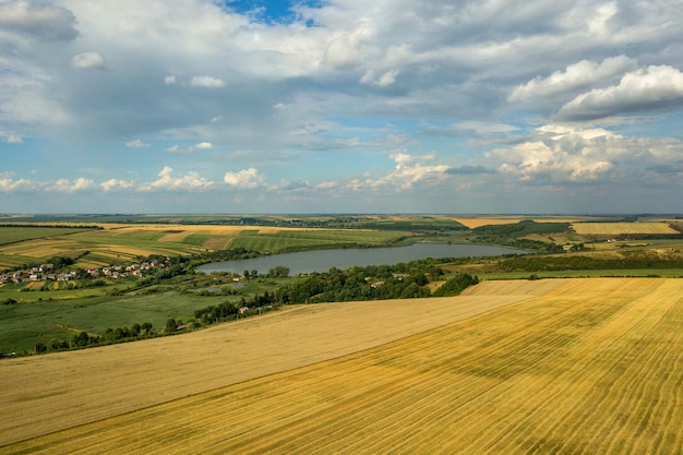 Aerial rural landscape with yellow patched agriculture fields 