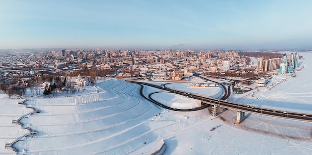 Aerial shot of bridge and car driving on the bridge winter sunny day in barnaul siberia russia