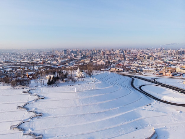 Aerial shot of bridge and car driving on the bridge winter sunny day in barnaul siberia russia