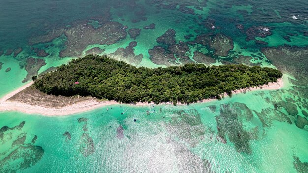 Aerial shot of a green island surrounded by tranquil ocean water in Bocas del Toro Panama