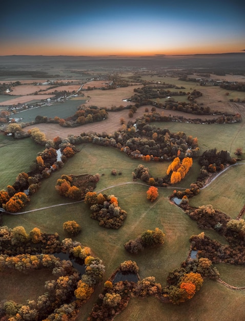 Aerial shot of a landscdape in autumn during the sunset