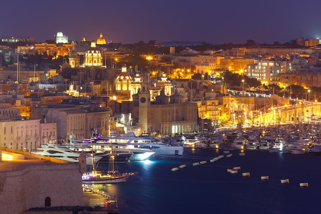 Aerial skyline view of Birgu - one of Three cities, as seen from Valletta at night, Malta.