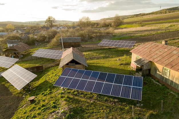 Aerial top down view of solar panels in green rural village yard.