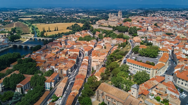 Aerial top view of Beziers town, river and bridges from above, South France