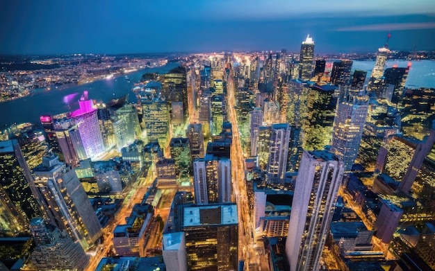 Aerial top view of downtown district buildings in night city light Bird's eye view from drone